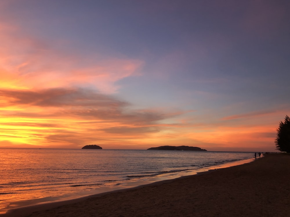 body of water during sunset