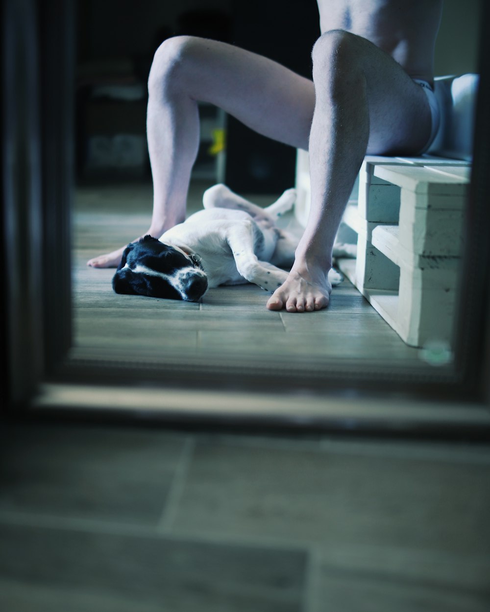 person in black shorts sitting on floor