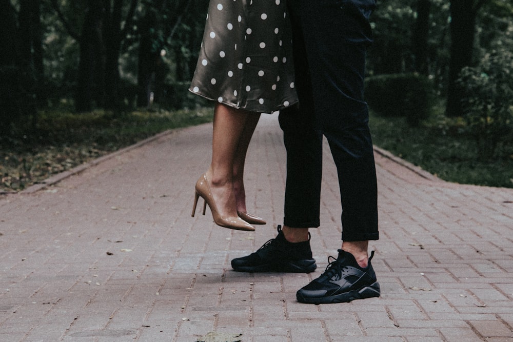 person in black and white polka dot dress