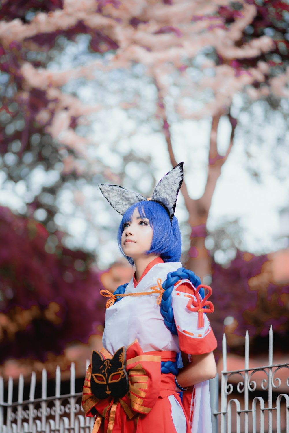 blue haired girl in red and white dress figurine