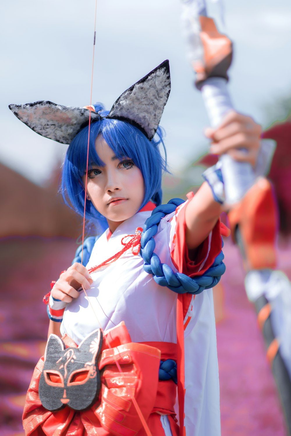 girl in blue and red long sleeve shirt holding a umbrella