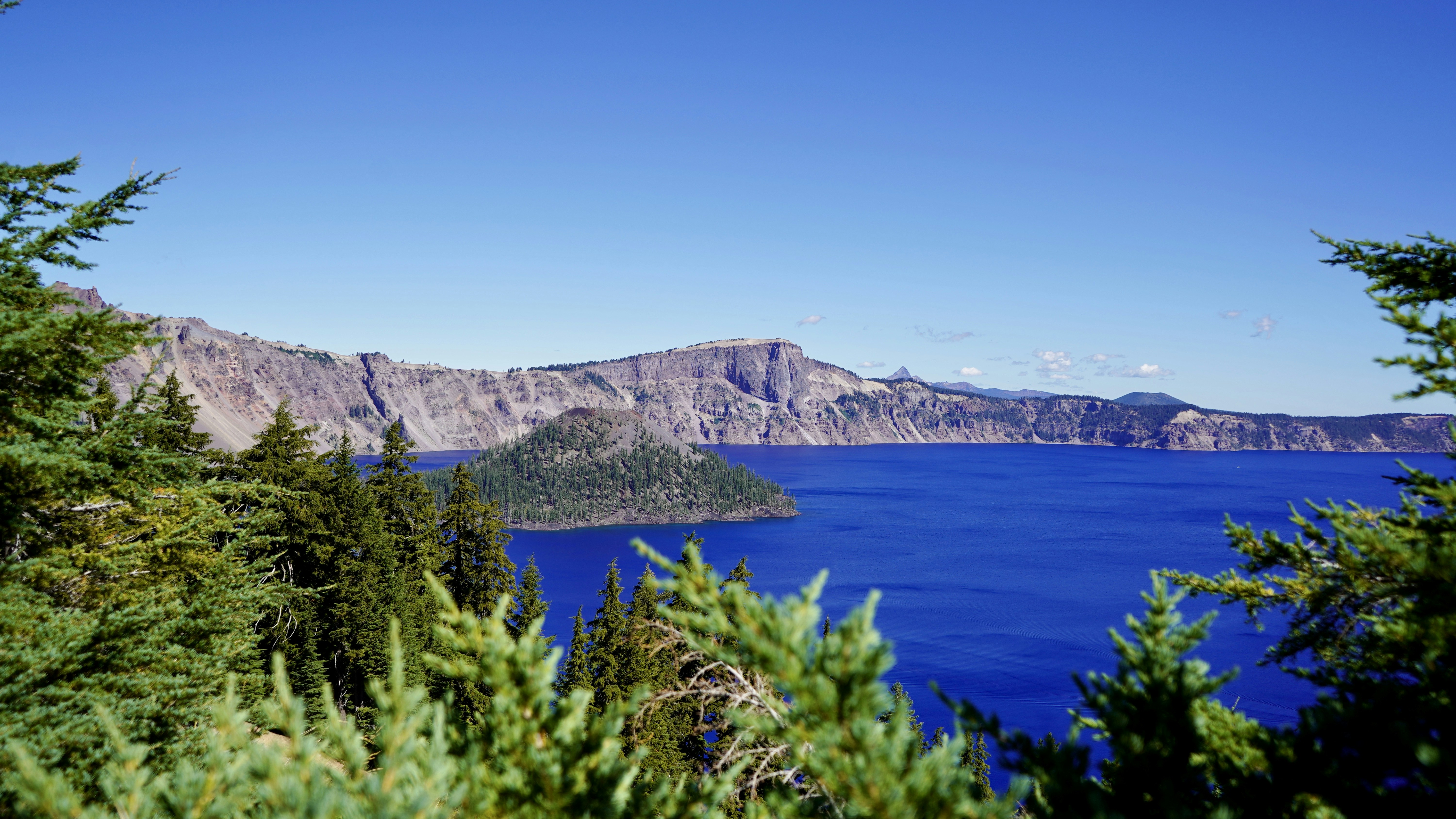 green trees near body of water during daytime, Crater surrounded by a beautiful blue lake!