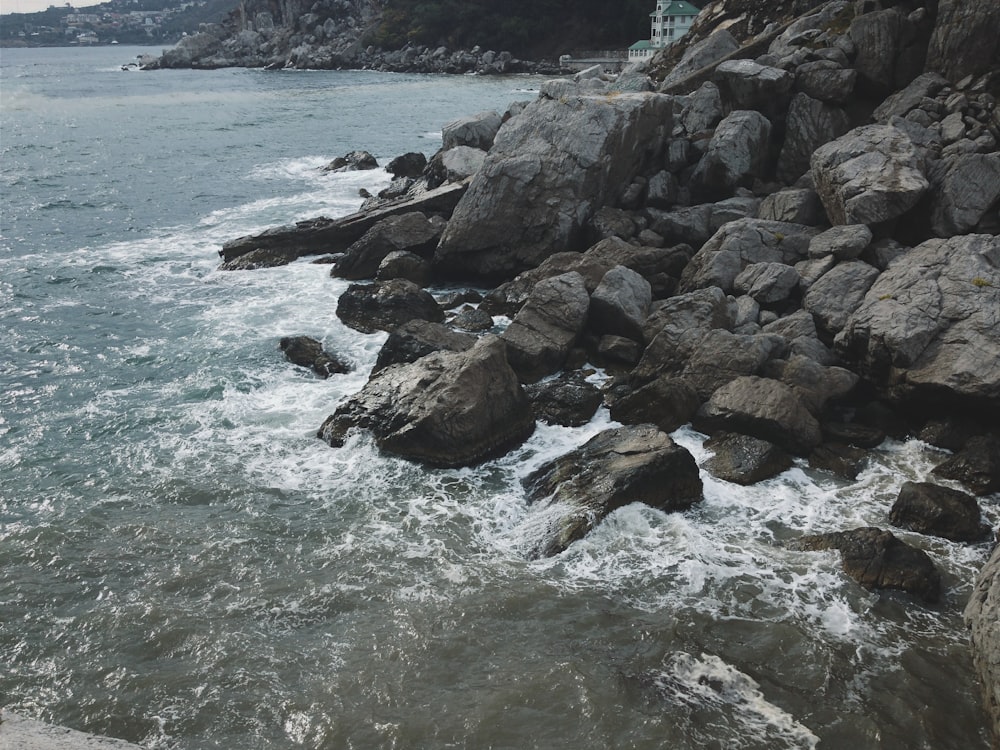 brown rocks on sea shore during daytime