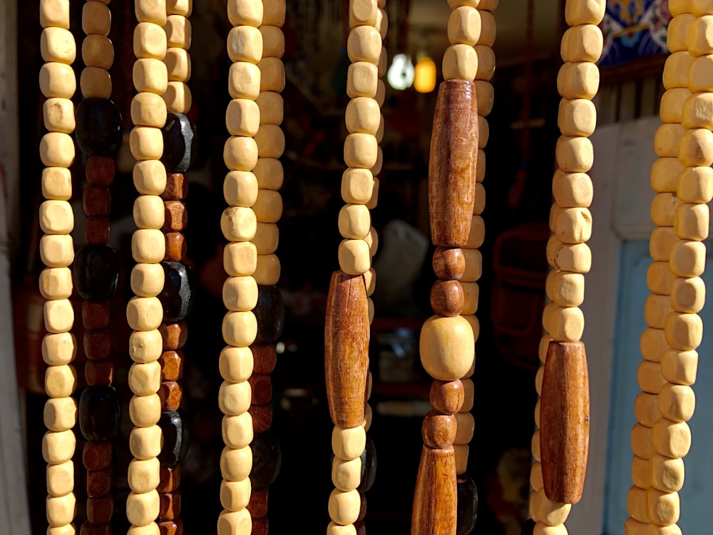 brown wooden beaded necklace on brown wooden rack