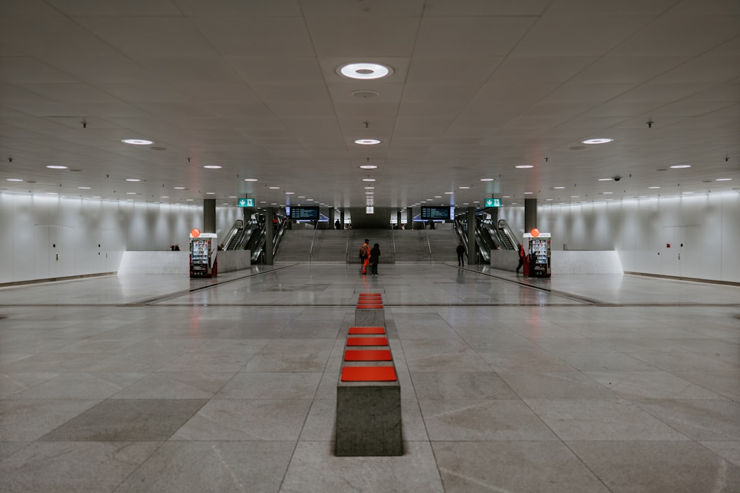 people walking on white floor tiles