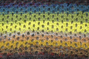 A grid display of various örme (knitted) fabric swatches highlighting their stretch and texture