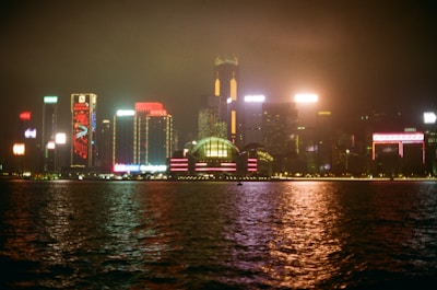 A night cityscape with neon lights reflecting a lively, exciting atmosphere.