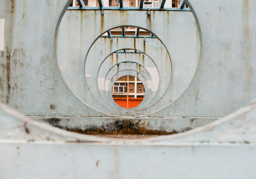 gray concrete tunnel with red metal door