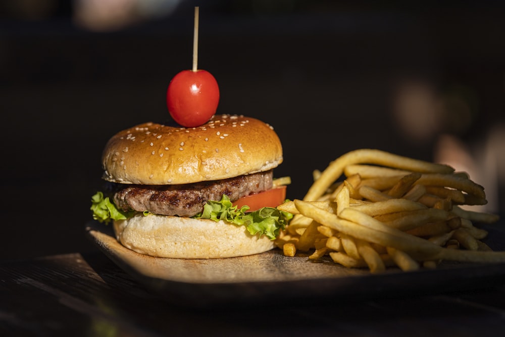 burger with lettuce and tomato on black tray