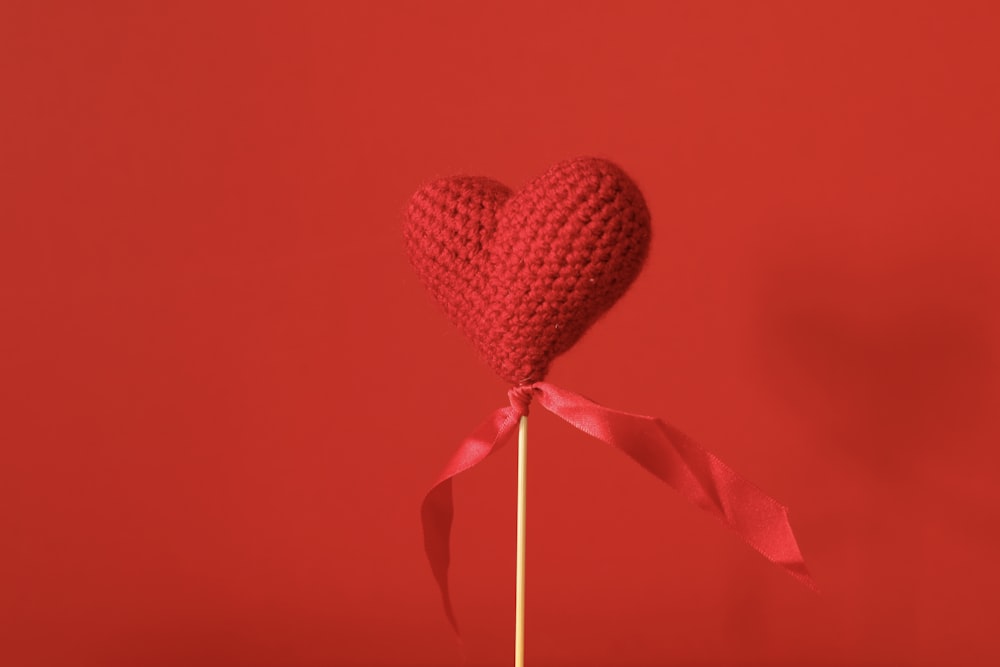 red heart shaped lollipop on red textile