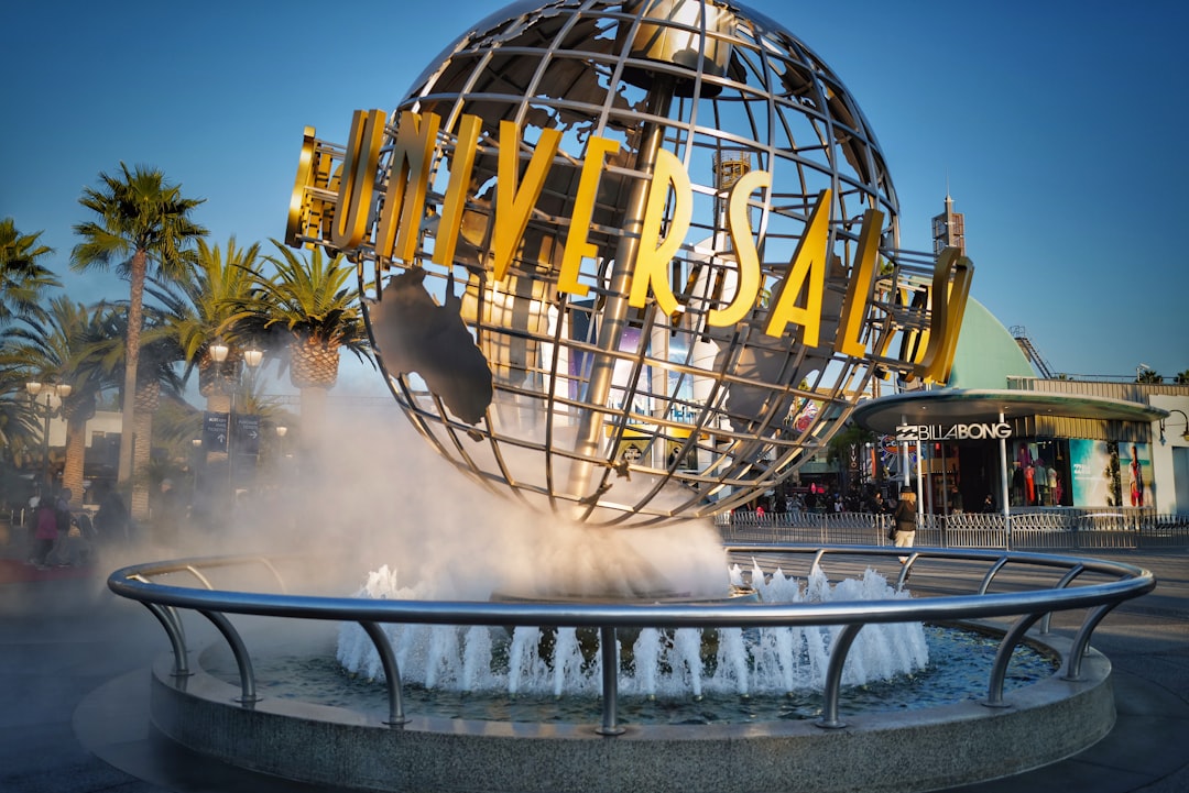 water fountain near yellow and black building during daytime