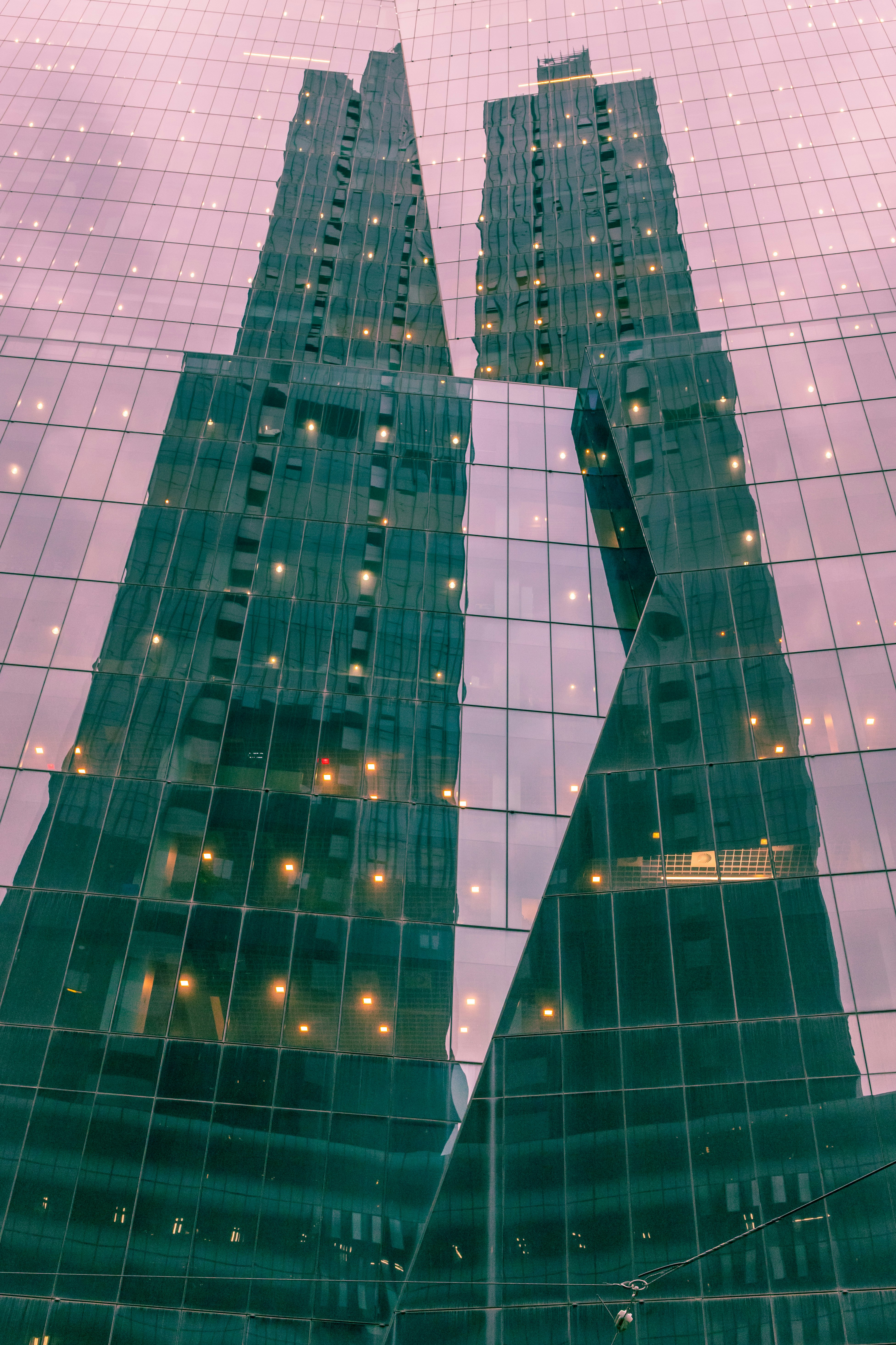 blue and white glass walled high rise building