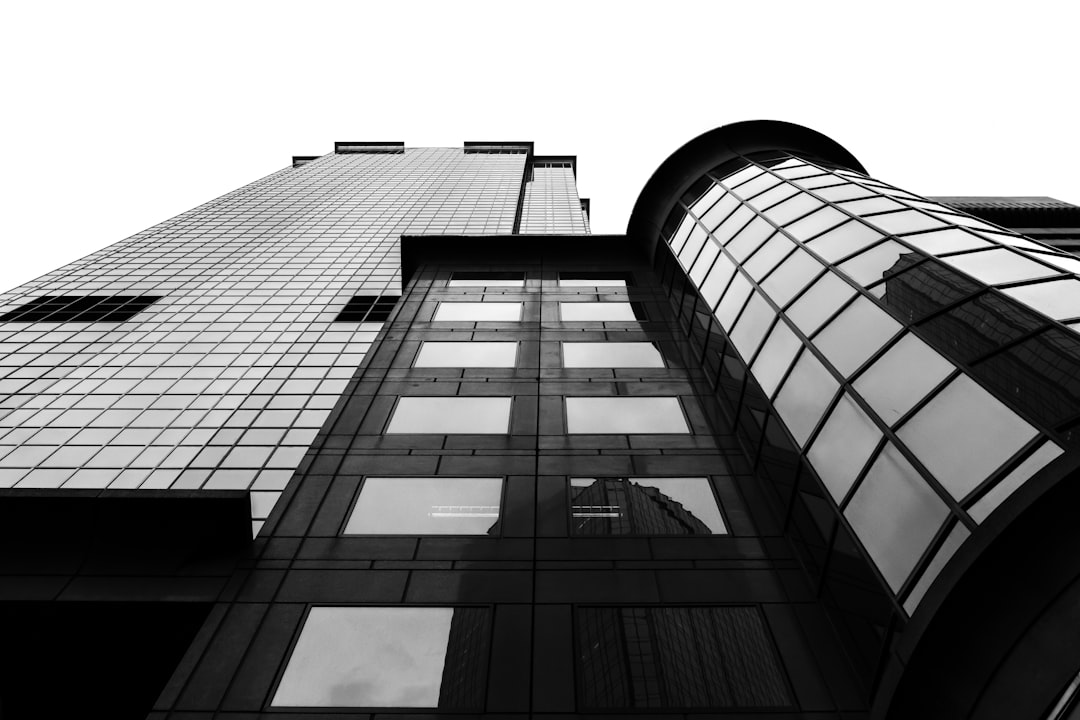 grayscale photo of glass walled building