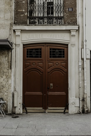 red wooden door on white concrete building