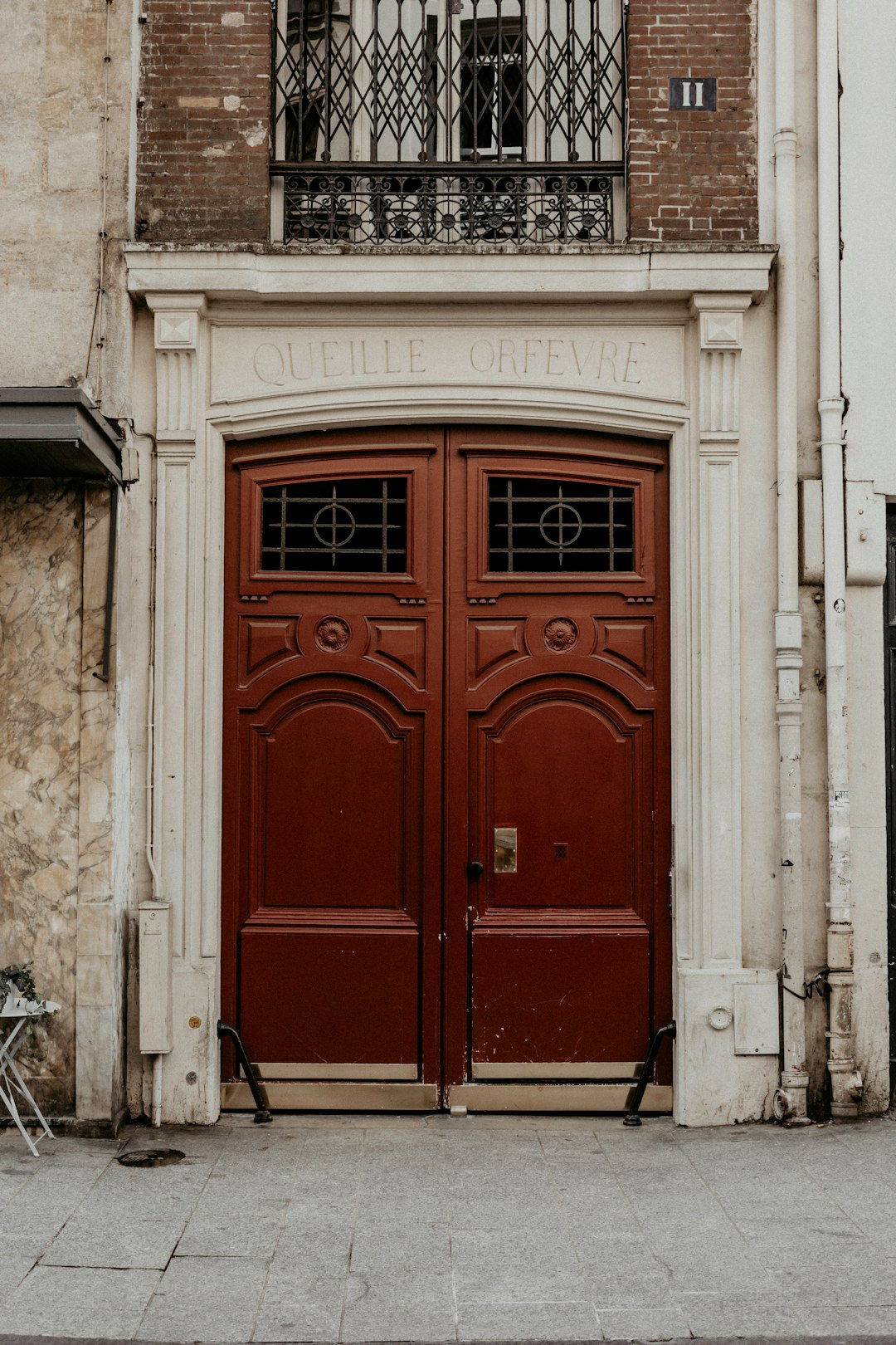 red wooden door on white concrete building