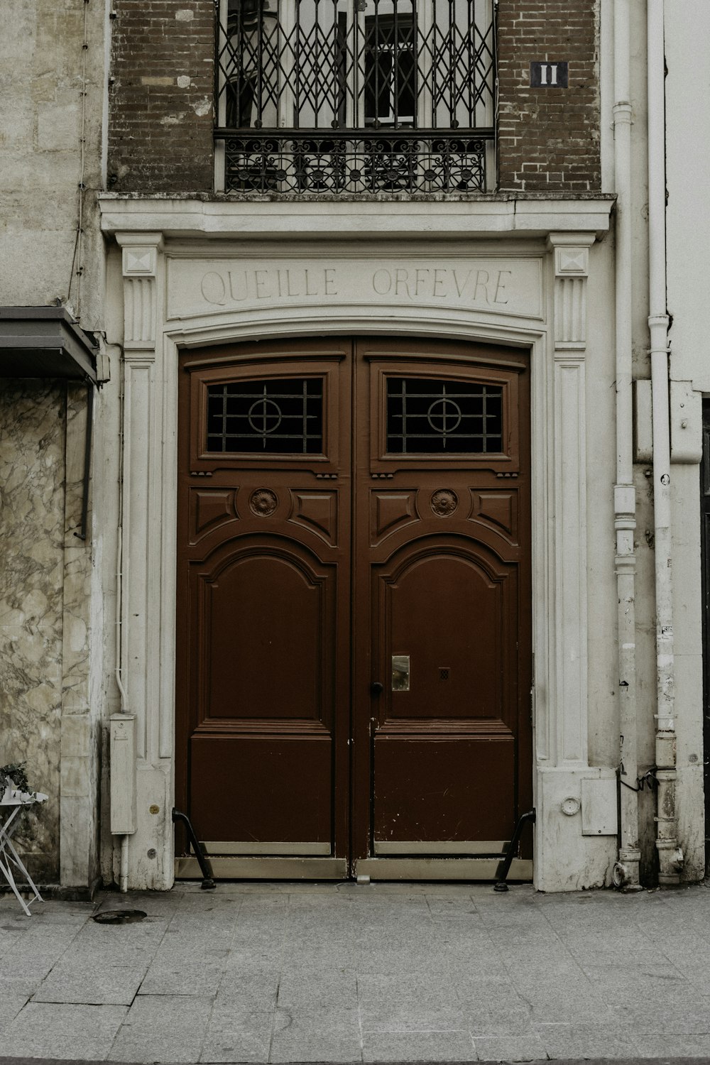 red wooden door on white concrete building