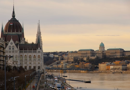 brown and white concrete building near body of water during daytime in Hungarian Parliament Building Hungary