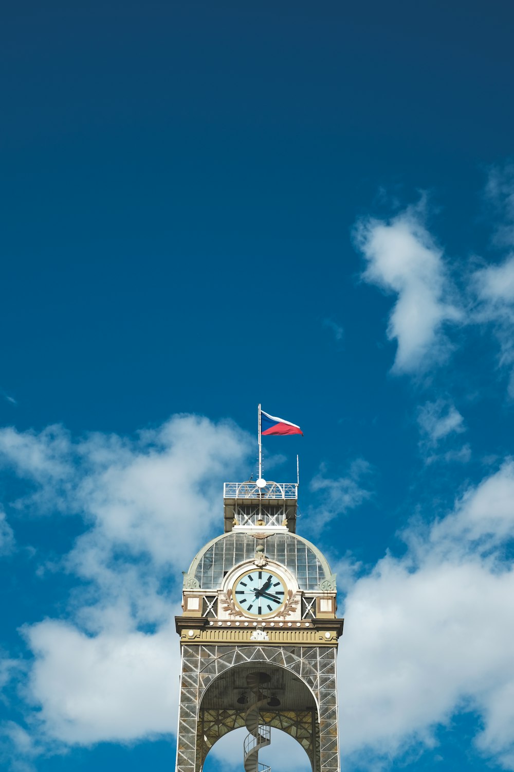 brown and black tower clock under blue sky