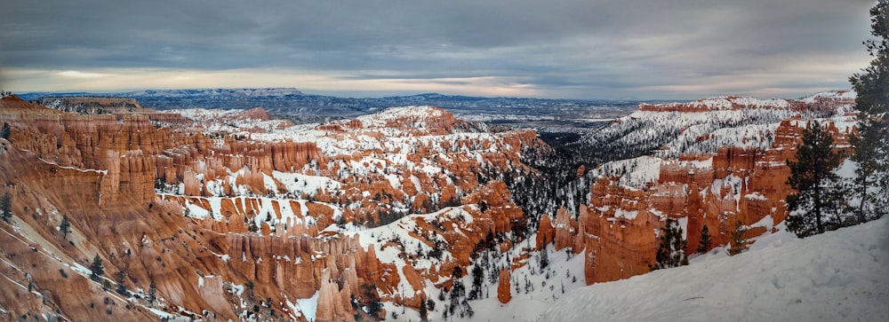 brown and white mountains under white clouds during daytime