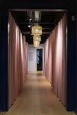 Softly lit hallway with contemporary feminine design elements in warm tones.