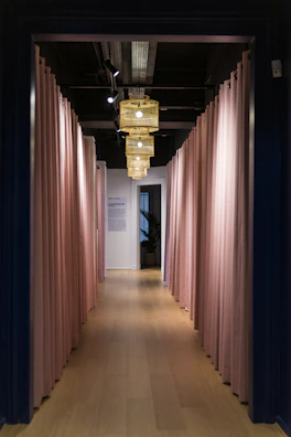Softly lit hallway with contemporary feminine design elements in warm tones.