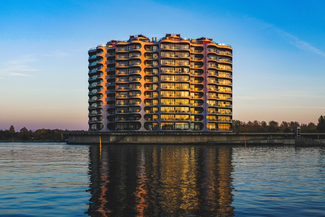 brown and white high rise building near body of water during daytime