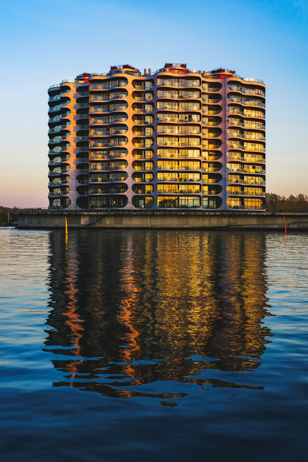 brown and black high rise building near body of water during daytime