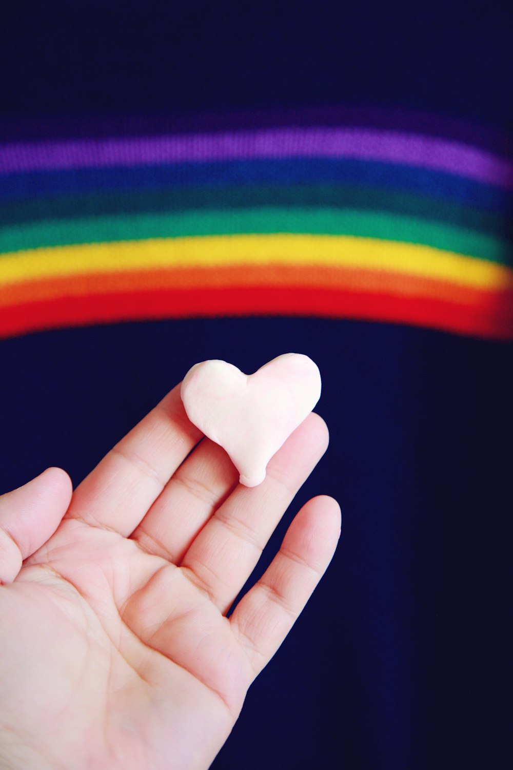 person holding white heart shaped ornament