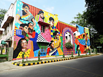 A vibrant urban mural painted by six artists blending colors and styles on a city wall.