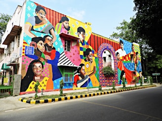 A vibrant mural painting showcasing a blend of colors and diverse artistic styles in an urban setting.