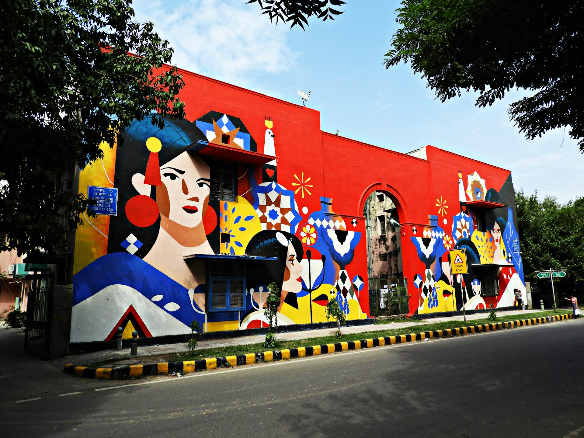A vibrant mural painted on a brownstone wall, capturing the essence of local culture with bold colors and dynamic figures.