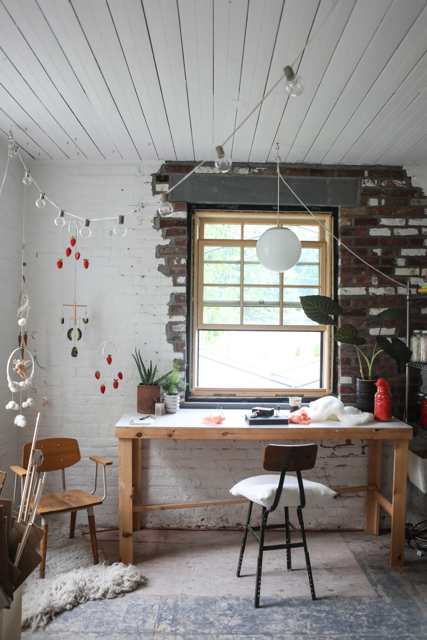 Refined interior with wood furniture, a table, chairs, rug, and natural light