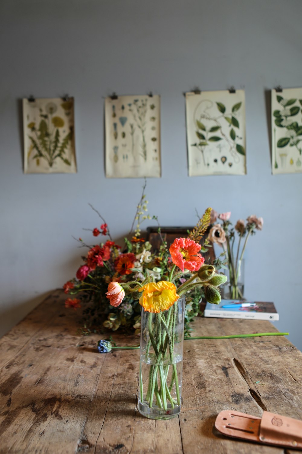 yellow and red flowers on blue ceramic vase