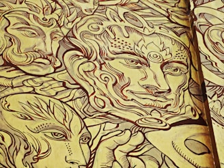 Intricate line art featuring abstract faces and patterns with ornate detailing. The design consists of multiple faces with stylized features, including exaggerated eyes and swirling patterns surrounding them. The use of bold lines and limited colors creates a unified and artistic composition.