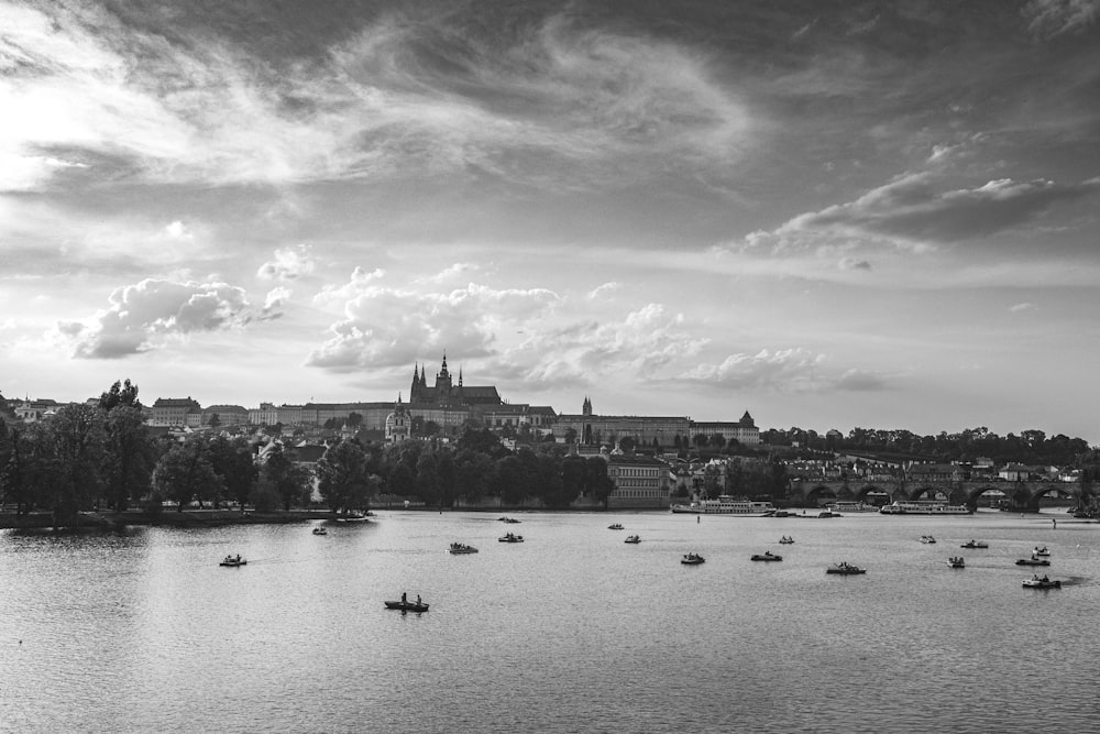 grayscale photo of body of water with boats