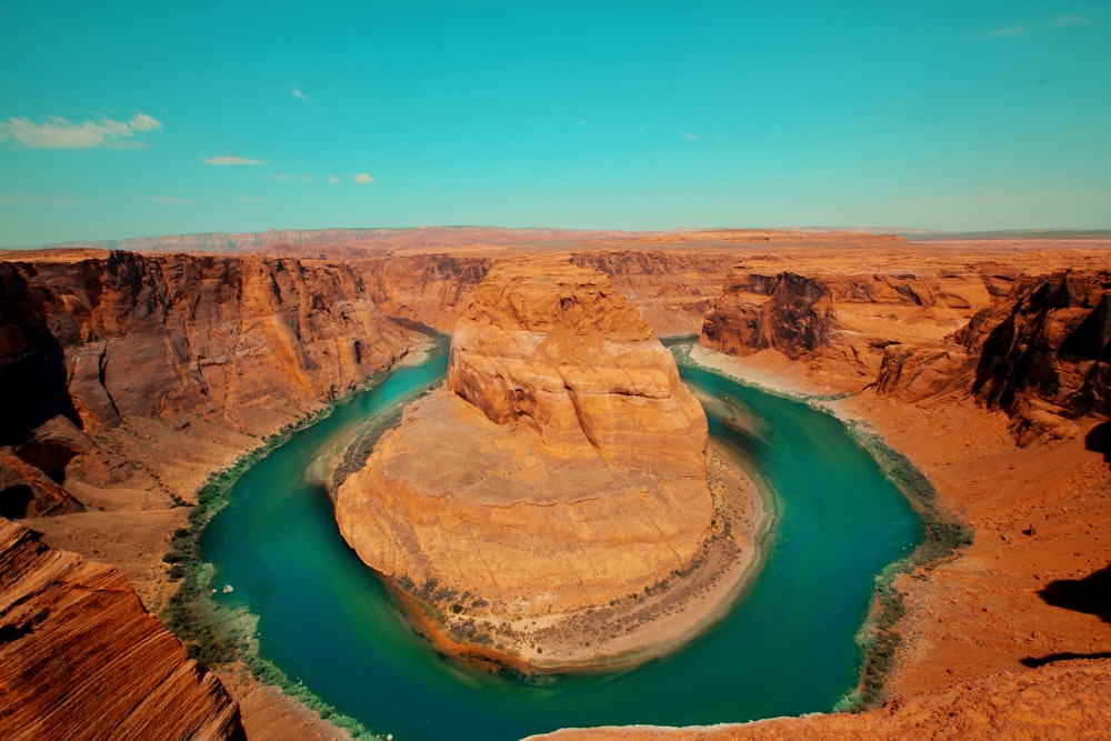 brown rock formation near body of water during daytime