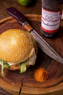 burger with lettuce and fries on brown wooden table