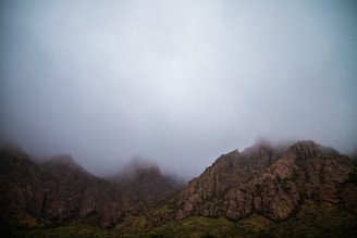 green and brown mountain under white clouds