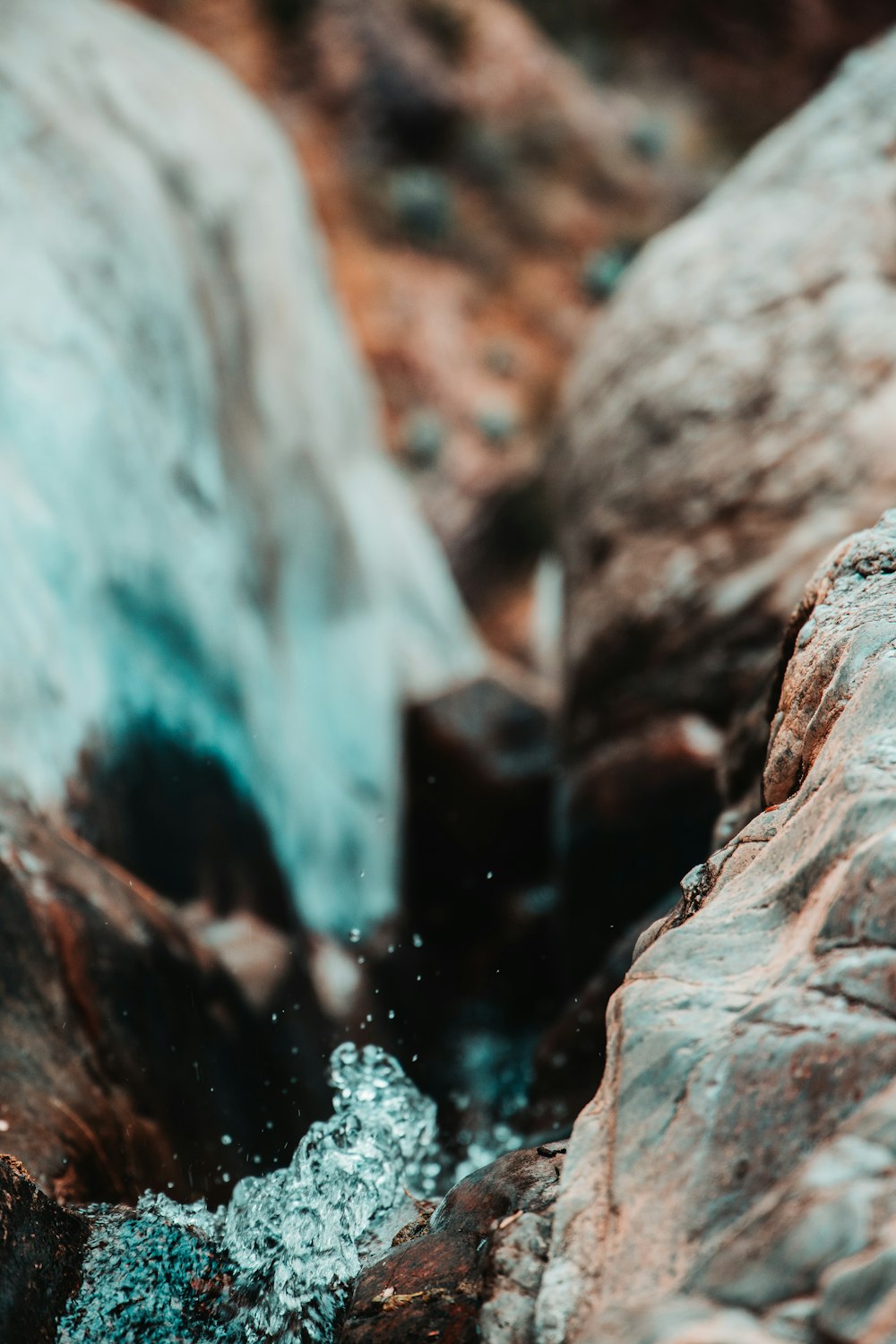 water flowing on brown rock
