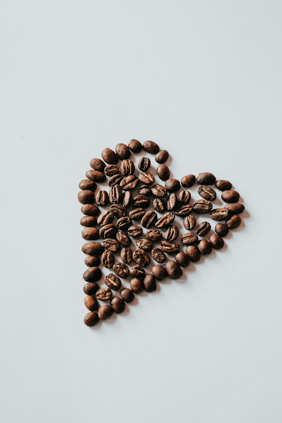 brown coffee beans on white surface