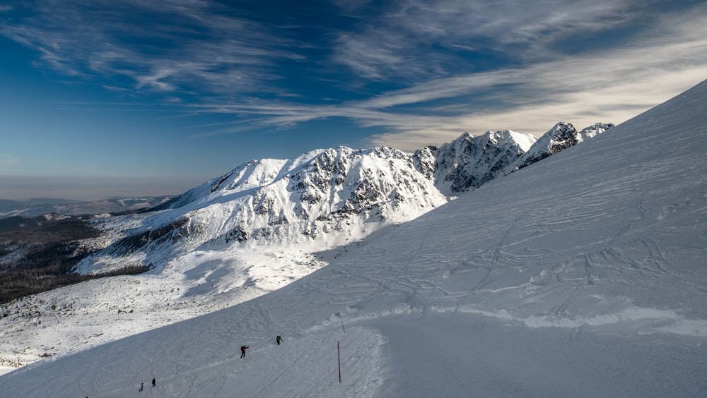 people walking on snow covered mountain during daytime