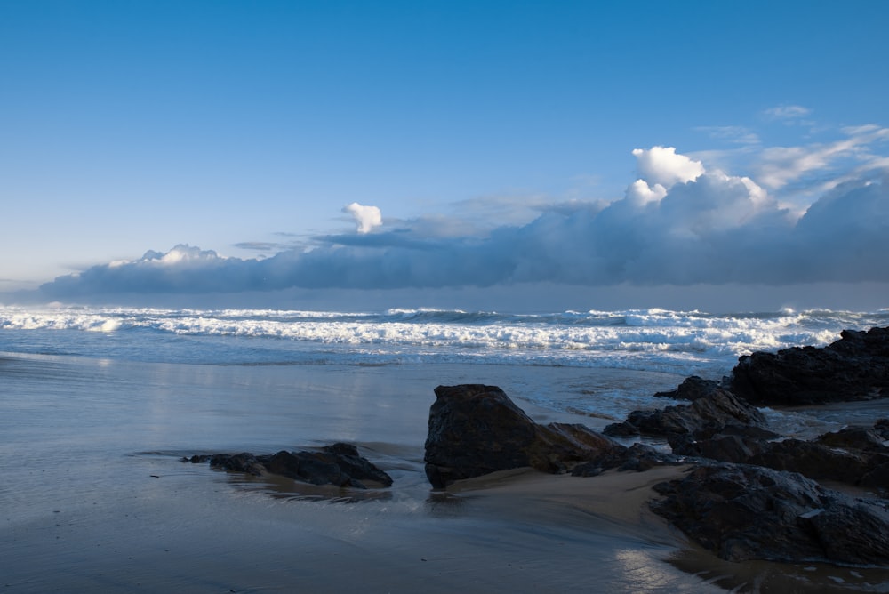 brown rock formation on sea shore during daytime