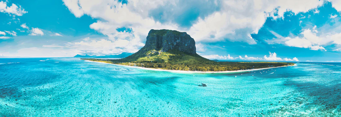 The peak of Le Morne Brabant rising above the turquoise lagoon of Mauritius