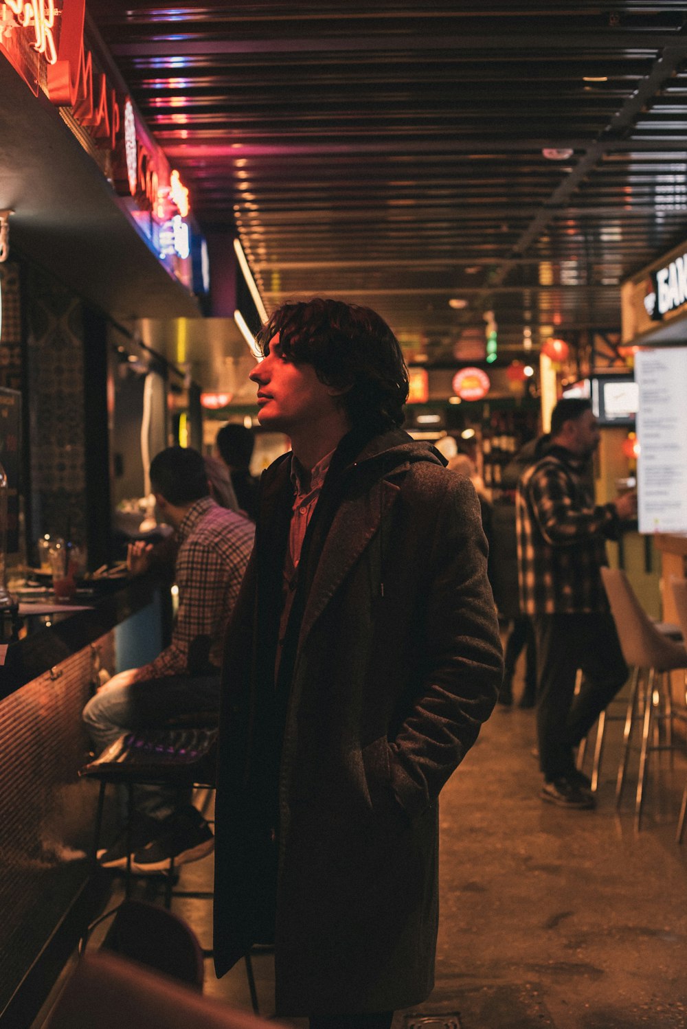 man in brown leather jacket sitting on chair