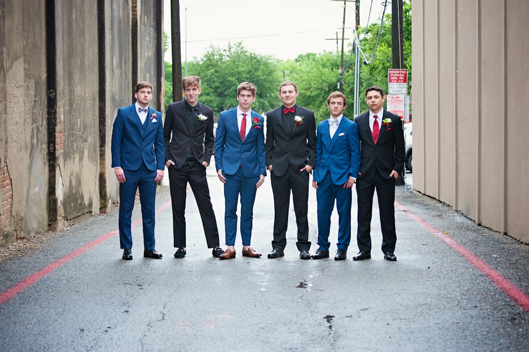 group of men in blue suit standing on gray concrete floor