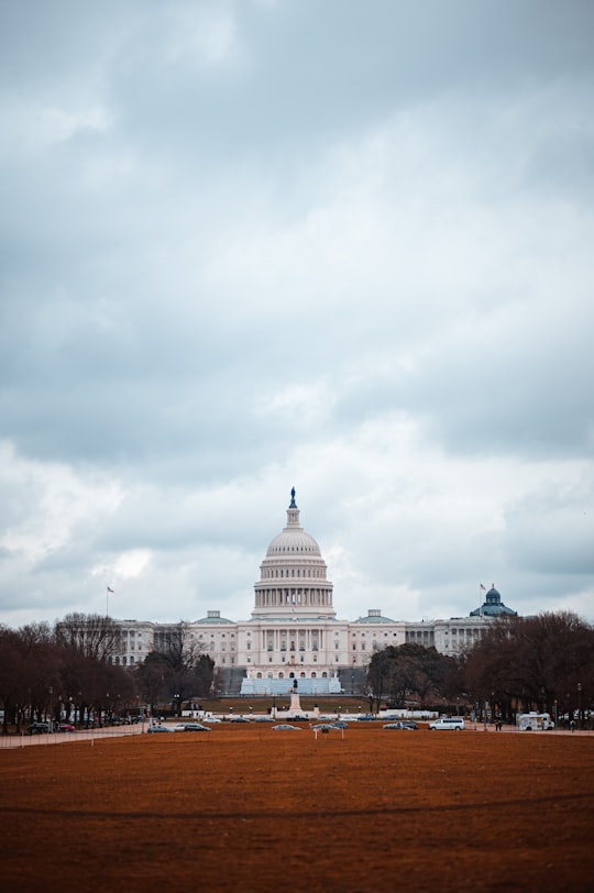 white concrete building under white clouds during daytime in U.S. Capitol United States