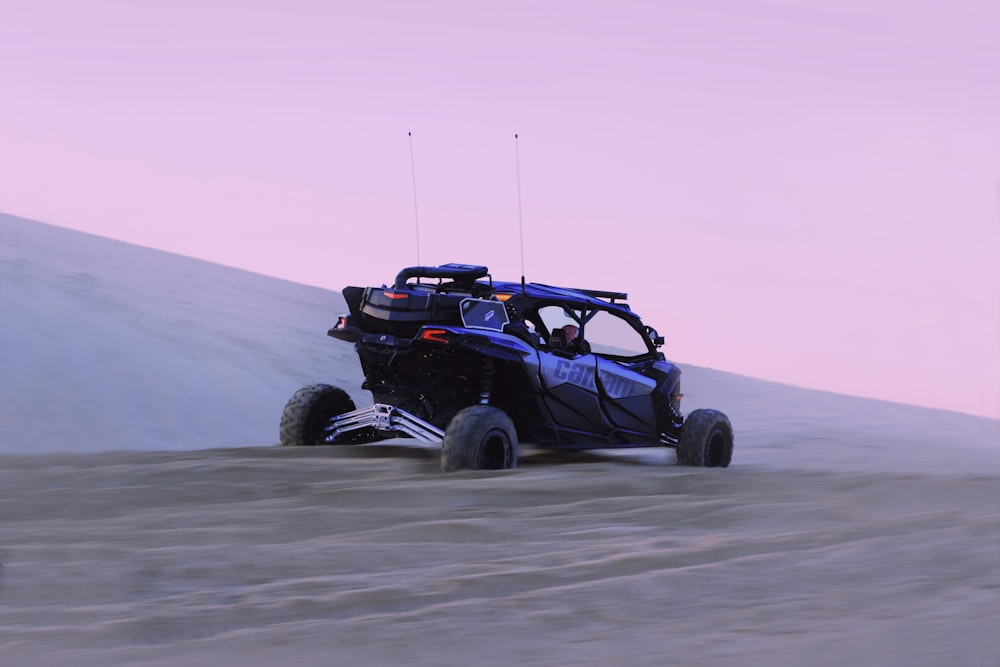 black and red jeep wrangler on gray sand during daytime