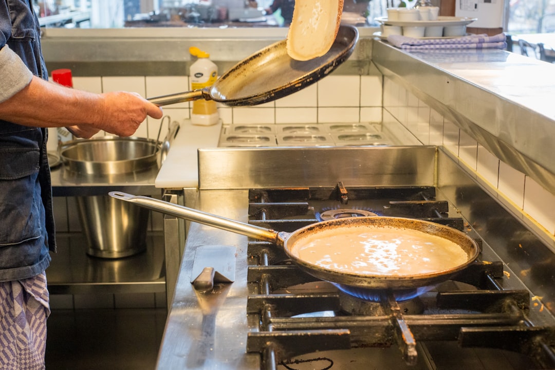 person cooking on stainless steel pan