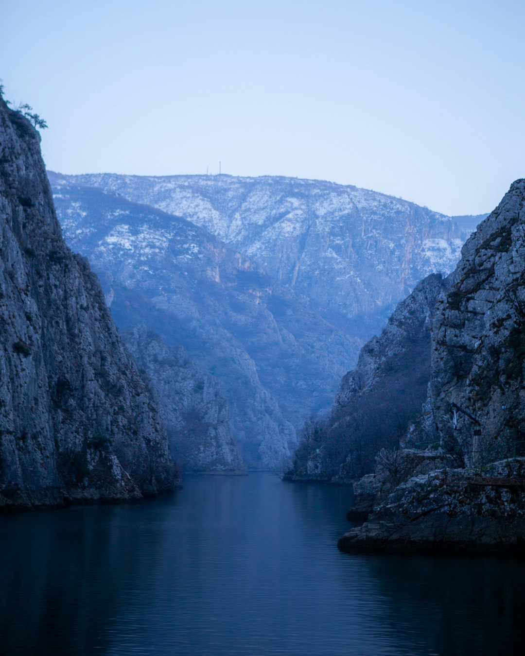 body of water between mountains during daytime