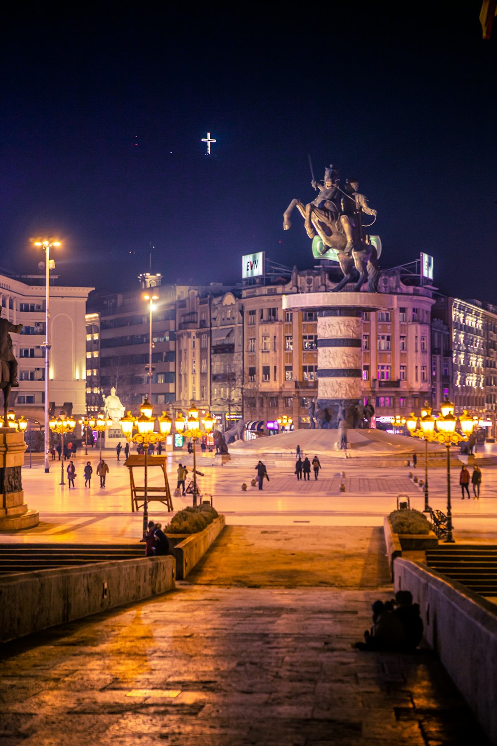 people walking on park near building during night time